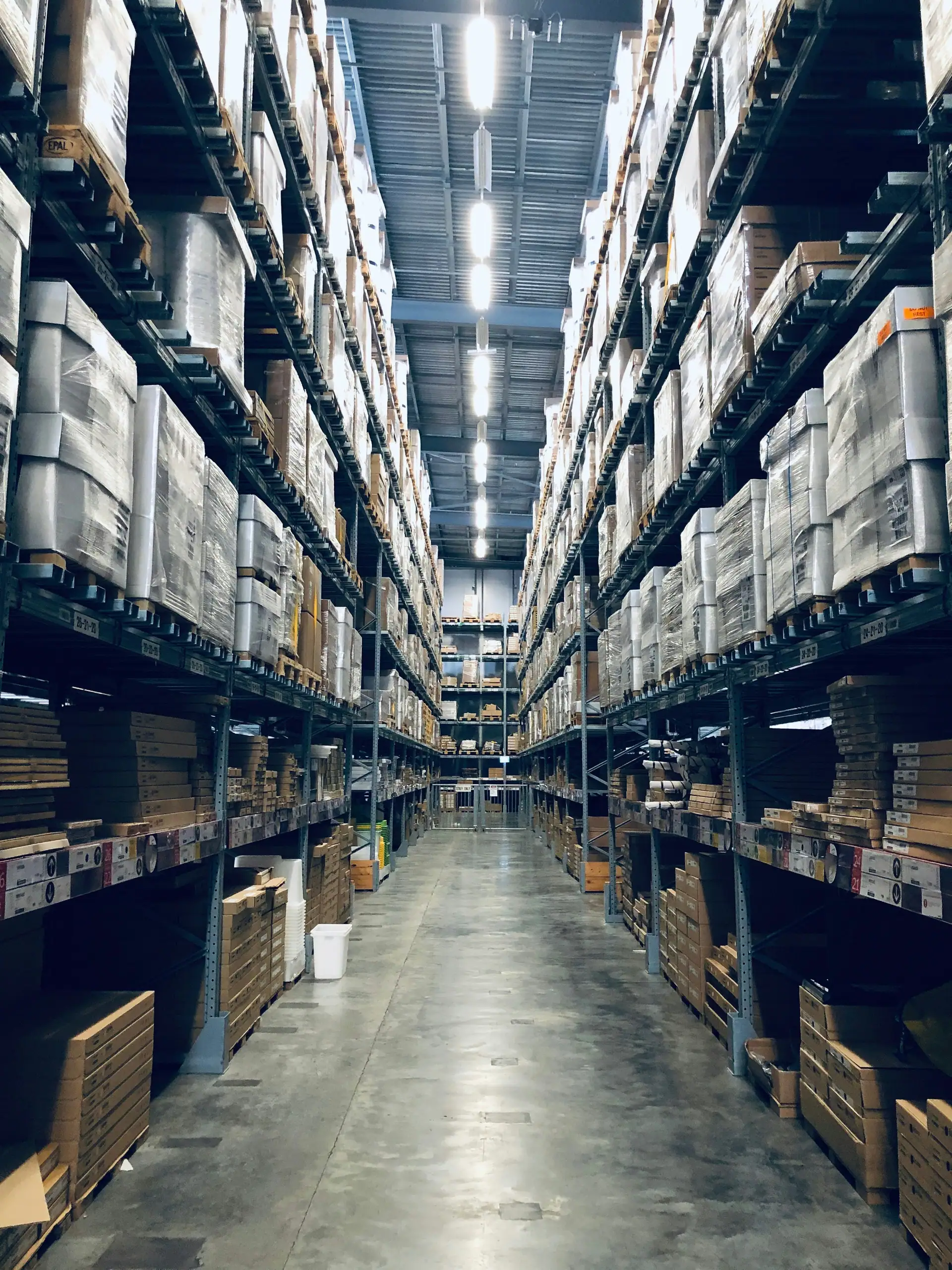 A long aisle between tall warehouse racks